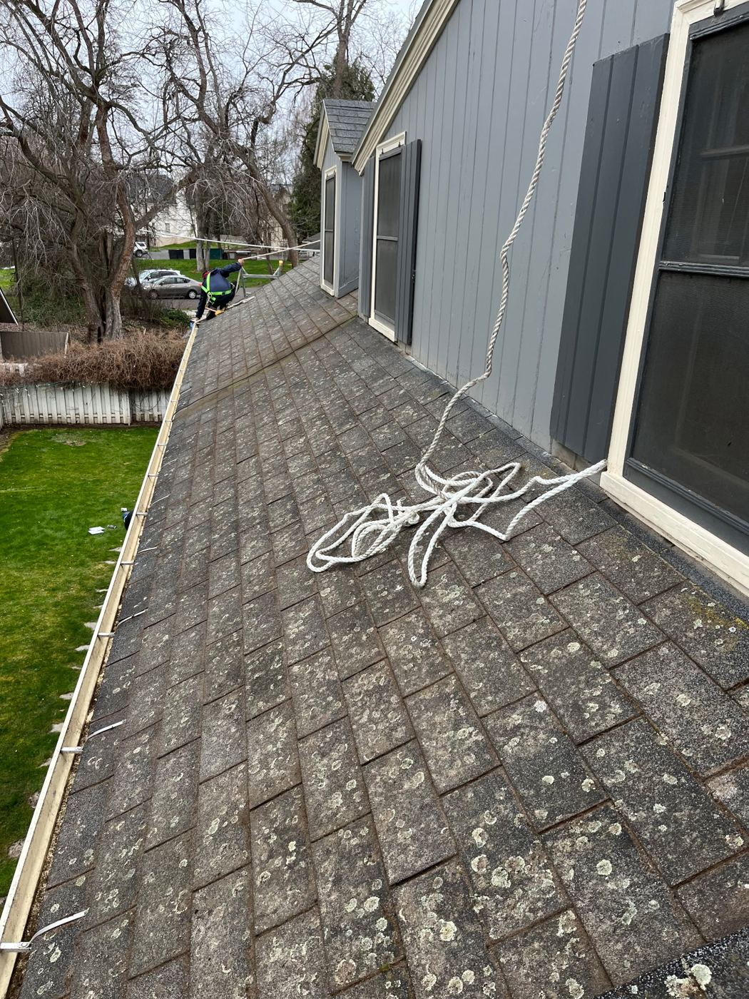 Cris Roofing crew member working along a roof edge